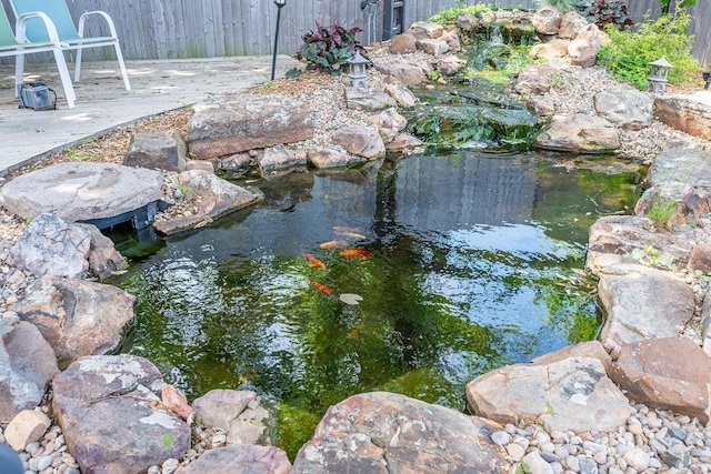 view of yard with a small pond and a deck