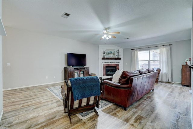 12308 Hickory Creek Blvd, Oklahoma City, OK 73170 - living room with ceiling fan, a fireplace, light wood-style floors, and baseboards