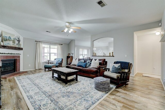 12308 Hickory Creek Blvd, Oklahoma City, OK 73170 - living room with light wood-type flooring, ceiling fan, a fireplace, and baseboards