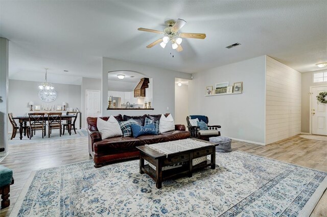 12308 Hickory Creek Blvd, Oklahoma City, OK 73170 - living area featuring wood finished floors, a ceiling fan, and a chandelier