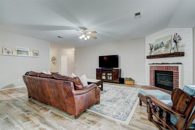 12308 Hickory Creek Blvd, Oklahoma City, OK 73170 - living room featuring wood finished floors, a ceiling fan, a brick fireplace, and baseboards