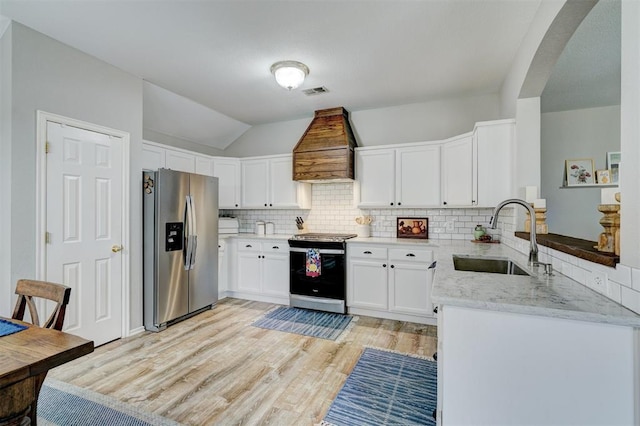12308 Hickory Creek Blvd, Oklahoma City, OK 73170 - kitchen featuring stainless steel refrigerator with ice dispenser, range with electric stovetop, a sink, custom exhaust hood, and light stone counters