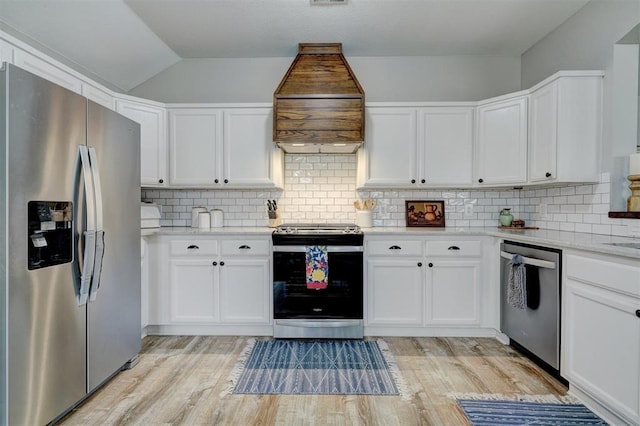 12308 Hickory Creek Blvd, Oklahoma City, OK 73170 - kitchen with appliances with stainless steel finishes, custom range hood, white cabinets, and vaulted ceiling