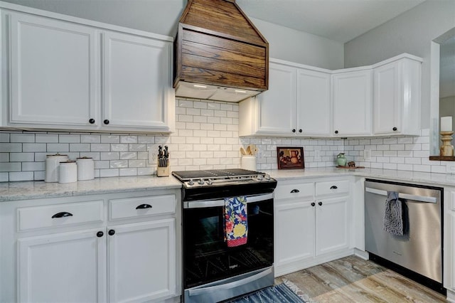 12308 Hickory Creek Blvd, Oklahoma City, OK 73170 - kitchen with stainless steel appliances, premium range hood, white cabinets, and light wood-style flooring