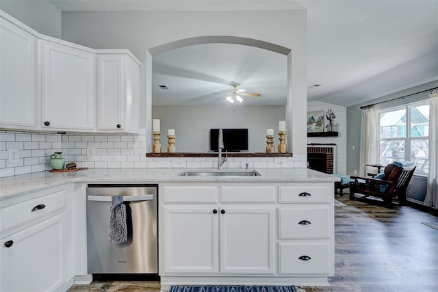 12308 Hickory Creek Blvd, Oklahoma City, OK 73170 - kitchen with dishwasher, a sink, arched walkways, a ceiling fan, and white cabinets