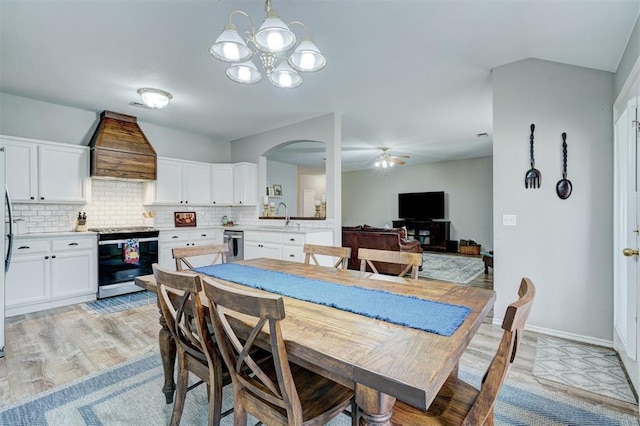 12308 Hickory Creek Blvd, Oklahoma City, OK 73170 - dining area with light wood-style flooring, ceiling fan, arched walkways, a chandelier, and baseboards