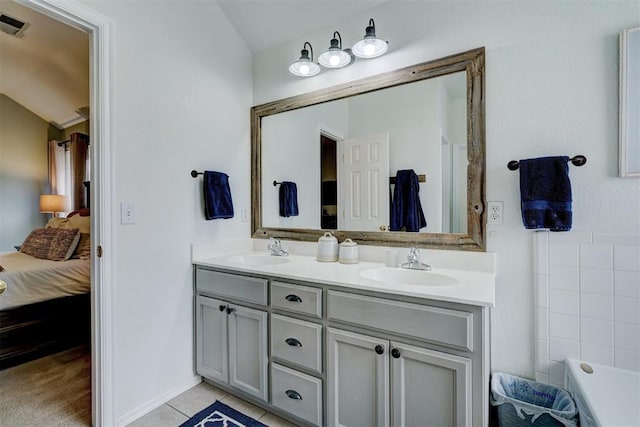 12308 Hickory Creek Blvd, Oklahoma City, OK 73170 - bathroom featuring ensuite bathroom, double vanity, tile patterned floors, and a bathtub