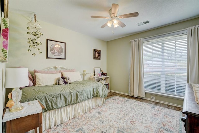 12308 Hickory Creek Blvd, Oklahoma City, OK 73170 - bedroom with wood finished floors, baseboards, and a ceiling fan
