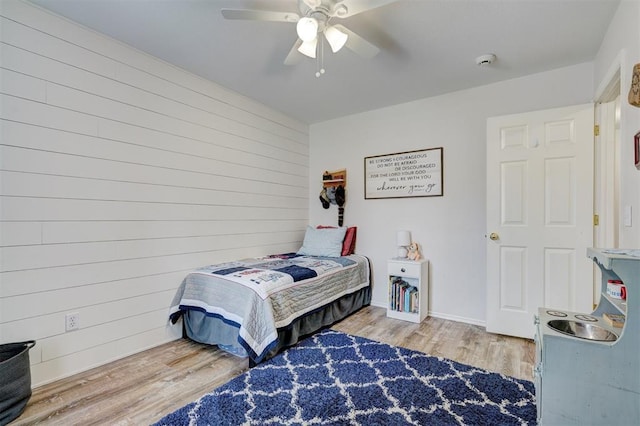 12308 Hickory Creek Blvd, Oklahoma City, OK 73170 - bedroom featuring wood finished floors, wood walls, and ceiling fan
