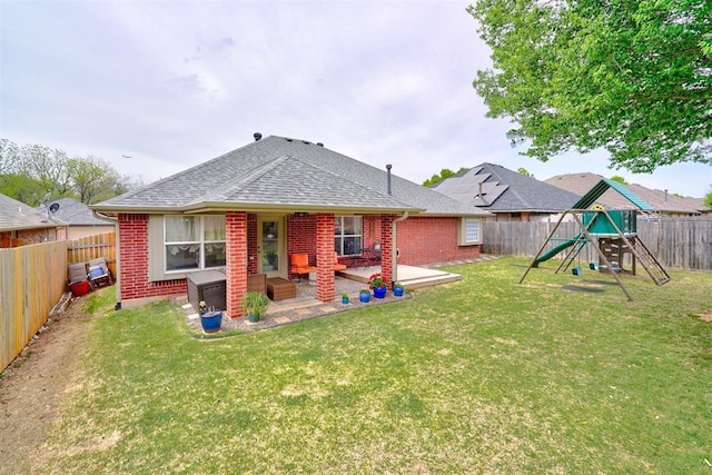 12308 Hickory Creek Blvd, Oklahoma City, OK 73170 - rear view of house featuring brick siding, a patio, a playground, and a shingled roof