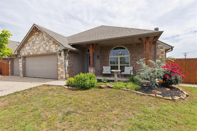 12116 NW 137th St, Piedmont, OK 73078 - view of front of house with covered porch, an attached garage, concrete driveway, stone siding, and a shingled roof