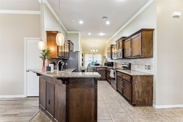 12116 NW 137th St, Piedmont, OK 73078 - kitchen featuring stainless steel appliances, a peninsula, a chandelier, light stone counters, and a breakfast bar