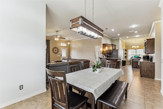 12116 NW 137th St, Piedmont, OK 73078 - dining space featuring light tile patterned flooring, a chandelier, crown molding, ceiling fan, and baseboards