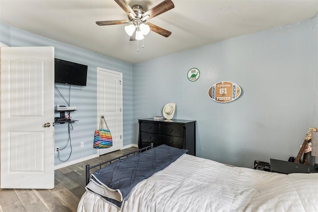 12116 NW 137th St, Piedmont, OK 73078 - bedroom with wood finished floors, a ceiling fan, and baseboards