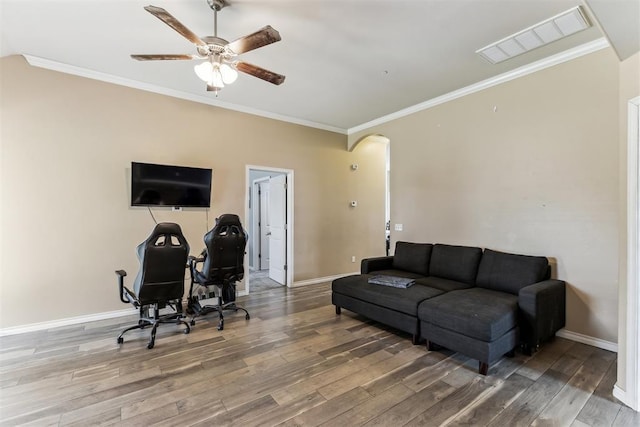 12116 NW 137th St, Piedmont, OK 73078 - living area featuring arched walkways, wood finished floors, a ceiling fan, baseboards, and crown molding