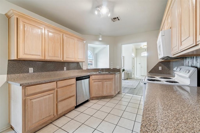 2013 Cedar Meadow Ln, Edmond, OK 73003 - kitchen featuring dishwasher, light brown cabinetry, white microwave, and a sink