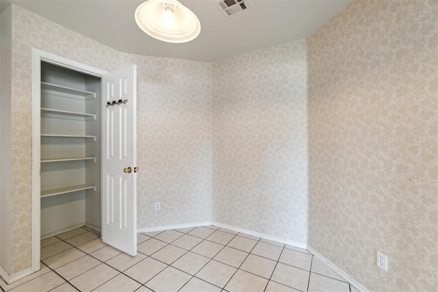 2013 Cedar Meadow Ln, Edmond, OK 73003 - unfurnished bedroom featuring wallpapered walls, light tile patterned floors, and baseboards