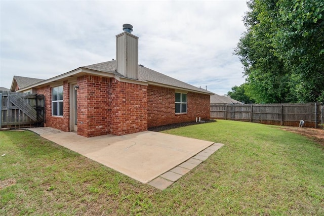 2013 Cedar Meadow Ln, Edmond, OK 73003 - rear view of property featuring brick siding, a patio, a chimney, and a shingled roof