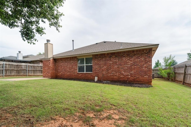 2013 Cedar Meadow Ln, Edmond, OK 73003 - back of property with brick siding, a chimney, and a shingled roof
