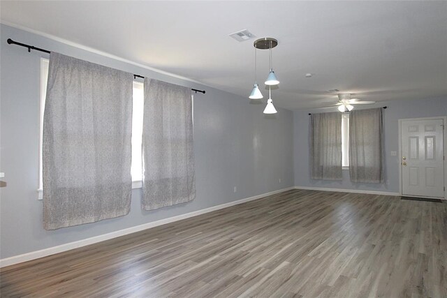 1016 N Louisa Ave, Shawnee, OK 74801 - unfurnished room with wood finished floors, baseboards, and ceiling fan