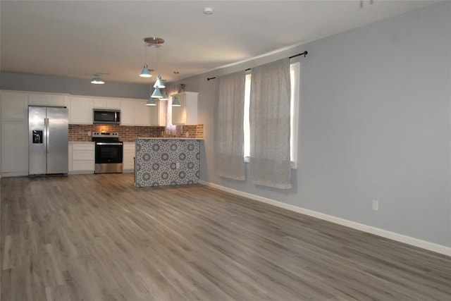1016 N Louisa Ave, Shawnee, OK 74801 - kitchen featuring appliances with stainless steel finishes, open floor plan, white cabinetry, and baseboards