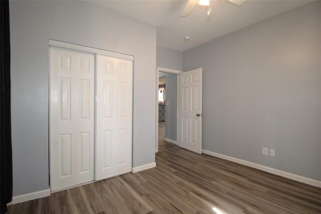 1016 N Louisa Ave, Shawnee, OK 74801 - unfurnished bedroom with wood finished floors, baseboards, a closet, and a ceiling fan