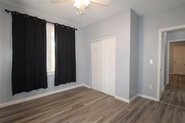1016 N Louisa Ave, Shawnee, OK 74801 - unfurnished bedroom featuring wood finished floors, baseboards, a closet, and ceiling fan