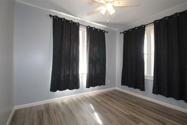 1016 N Louisa Ave, Shawnee, OK 74801 - spare room with wood finished floors, baseboards, and ceiling fan