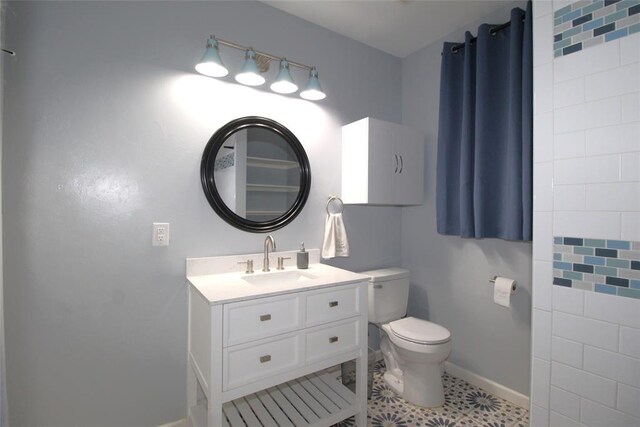 1016 N Louisa Ave, Shawnee, OK 74801 - bathroom with toilet, vanity, and baseboards