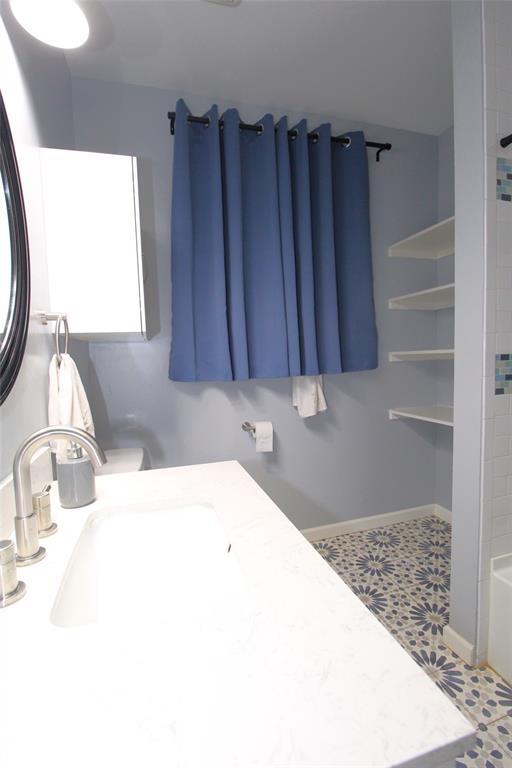 1016 N Louisa Ave, Shawnee, OK 74801 - bathroom with a sink, a shower, and a tub