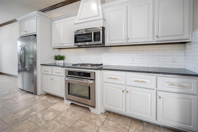 3716 Doningham Dr, Edmond, OK 73034 - kitchen featuring appliances with stainless steel finishes, white cabinets, decorative backsplash, and dark stone countertops
