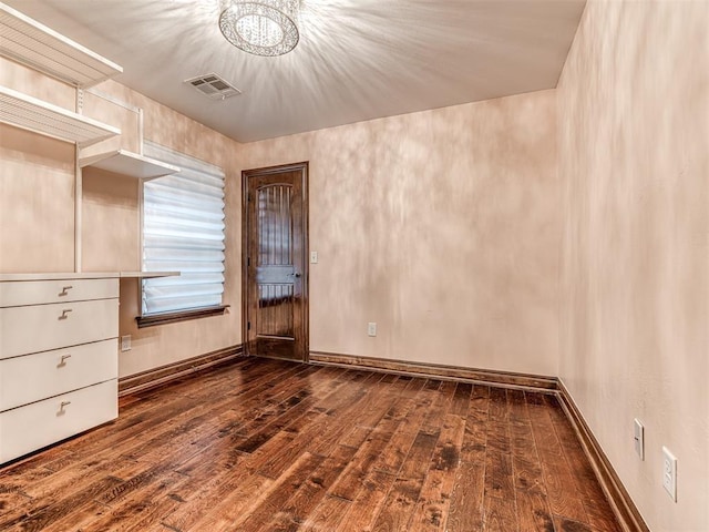 3716 Doningham Dr, Edmond, OK 73034 - unfurnished bedroom featuring dark wood-style flooring, a chandelier, and baseboards