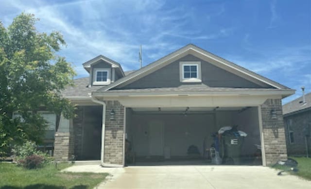 1037 Piper St, Norman, OK 73069 - view of front facade with concrete driveway, brick siding, and a garage