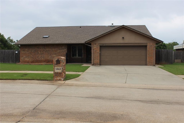 1343 Lowrie Ln, Oklahoma City, OK 73159 - view of front of property featuring driveway, brick siding, and an attached garage