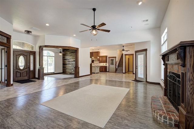 16371 Sandstone Cir, Choctaw, OK 73020 - foyer entrance with ceiling fan, light wood-style flooring, a brick fireplace, stairs, and recessed lighting