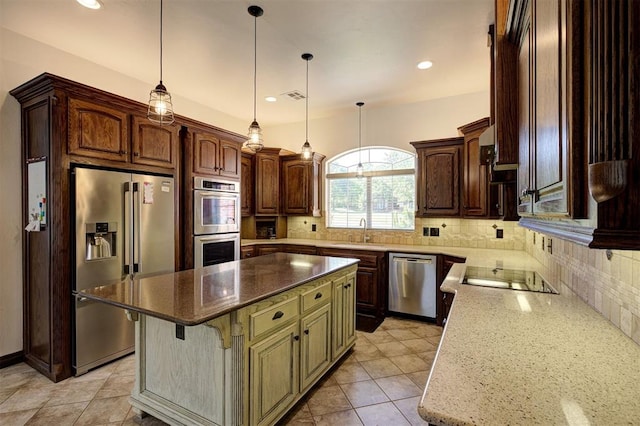 16371 Sandstone Cir, Choctaw, OK 73020 - kitchen featuring appliances with stainless steel finishes, a sink, a kitchen island, decorative backsplash, and dark stone counters
