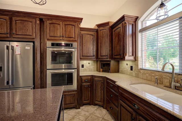 16371 Sandstone Cir, Choctaw, OK 73020 - kitchen featuring stainless steel appliances, a sink, tasteful backsplash, and plenty of natural light