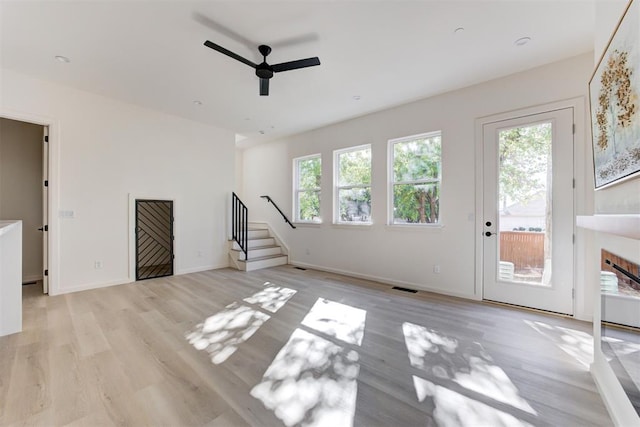 577 S Fretz Ave, Edmond, OK 73003 - unfurnished living room featuring ceiling fan, light wood-type flooring, stairs, baseboards, and a fireplace