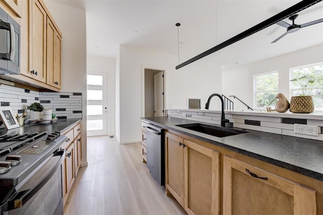 577 S Fretz Ave, Edmond, OK 73003 - kitchen with a sink, appliances with stainless steel finishes, dark countertops, and backsplash