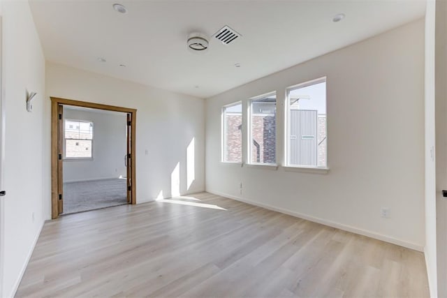 577 S Fretz Ave, Edmond, OK 73003 - unfurnished room with plenty of natural light, light wood-style flooring, and baseboards
