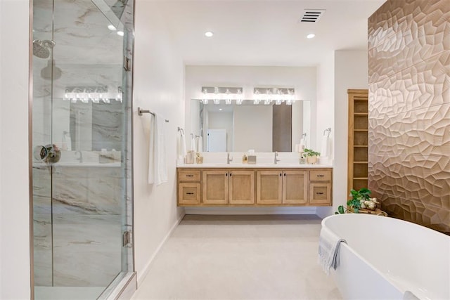 577 S Fretz Ave, Edmond, OK 73003 - bathroom featuring a stall shower, a freestanding tub, vanity, recessed lighting, and baseboards