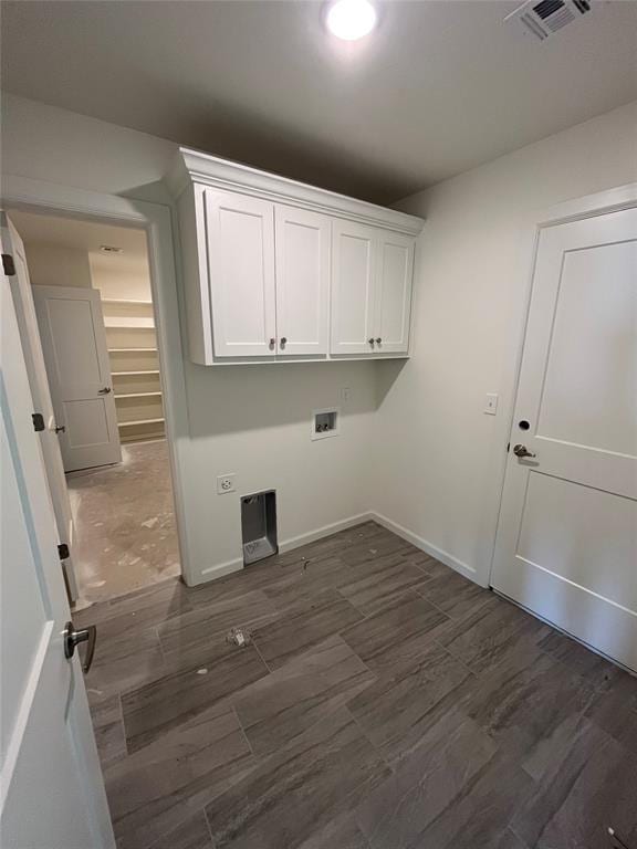 washroom with cabinet space, hookup for a washing machine, dark wood-style flooring, and baseboards