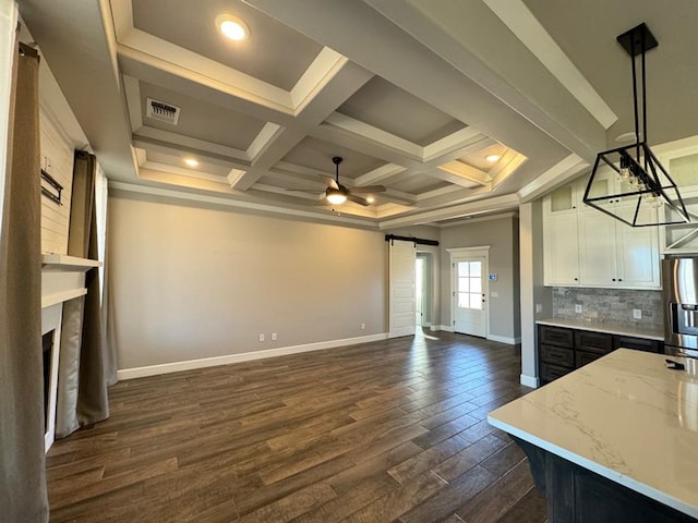 unfurnished living room featuring a barn door, baseboards, dark wood-type flooring, coffered ceiling, and ceiling fan