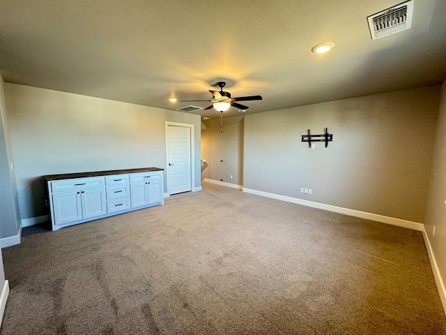 empty room with baseboards, light colored carpet, and ceiling fan