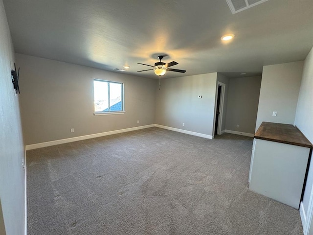 empty room featuring a ceiling fan, baseboards, carpet flooring, and recessed lighting