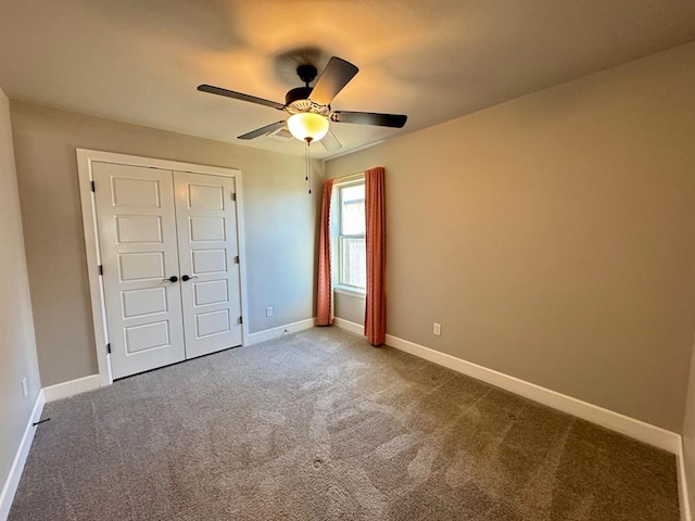 unfurnished bedroom featuring carpet flooring, baseboards, a closet, and ceiling fan
