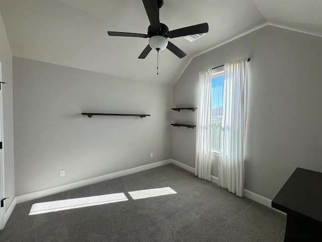 unfurnished bedroom featuring vaulted ceiling, carpet, baseboards, and a ceiling fan
