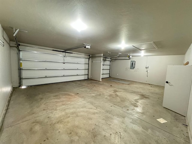garage featuring a garage door opener and electric panel
