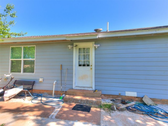 property entrance featuring a patio area