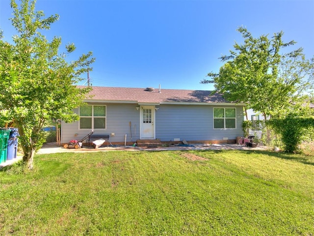 back of house featuring a yard and entry steps